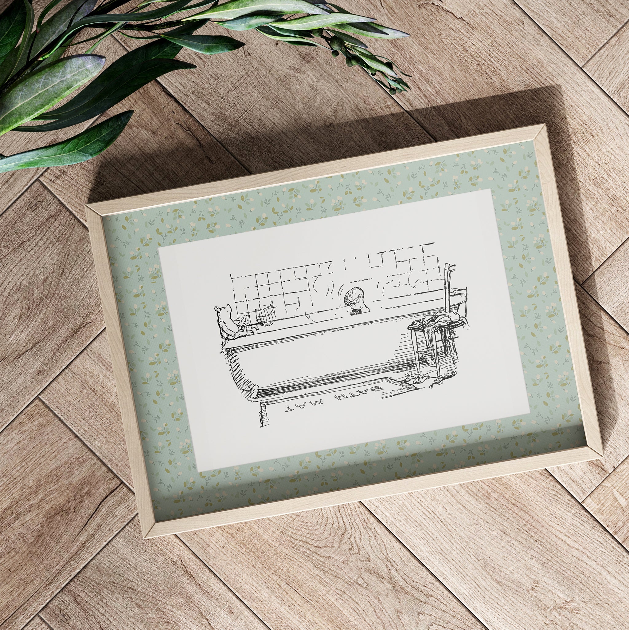 A children's bathroom print of Winnie-the-Pooh and Christopher Robin with a sage green patterned border